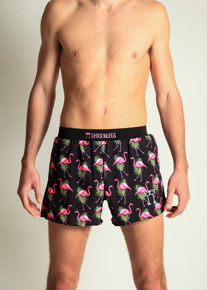 ChicknLegs men's black shorts with pink flamingo tropical pattern on model