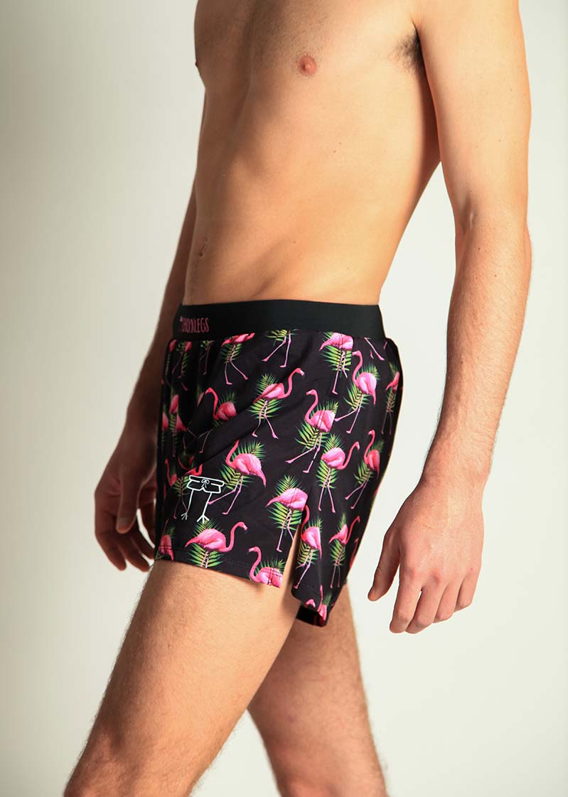 ChicknLegs 4-inch half split running shorts in black flamingo print on male model