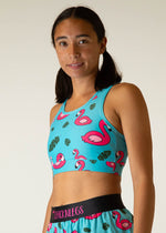 Woman wearing turquoise sports bra with pink flamingo pattern by ChicknLegs