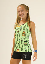 Woman wearing light green performance singlet with cartoon pickle pattern and black shorts