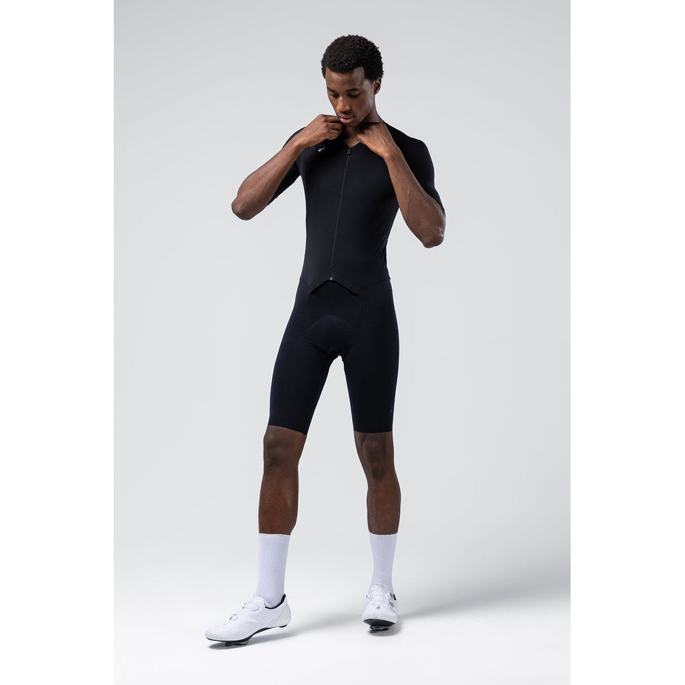 Man wearing black Gobik Integral Hudson cycling skinsuit with short sleeves and shorts