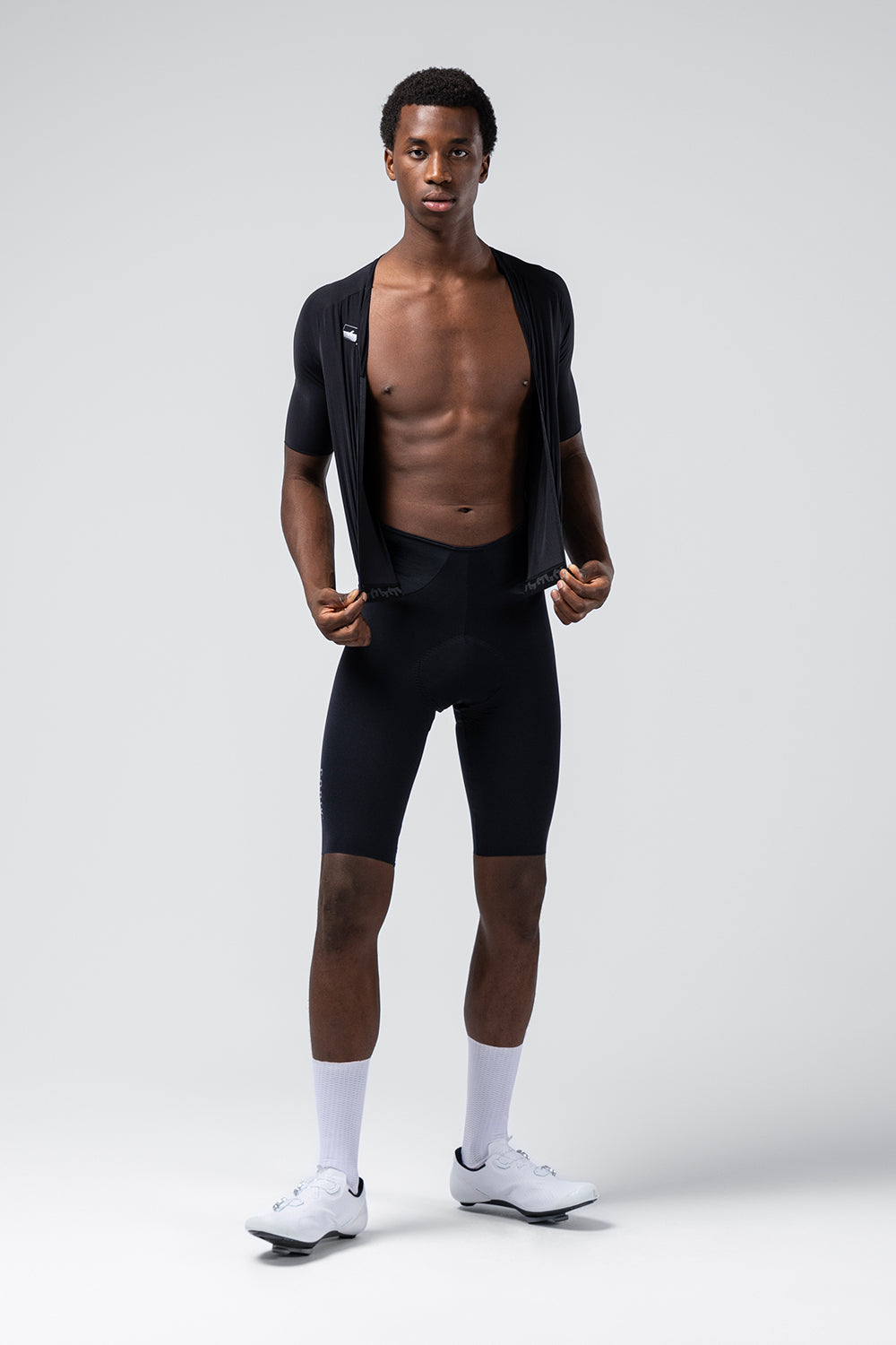 Male model wearing black Gobik cycling bib shorts with matching top