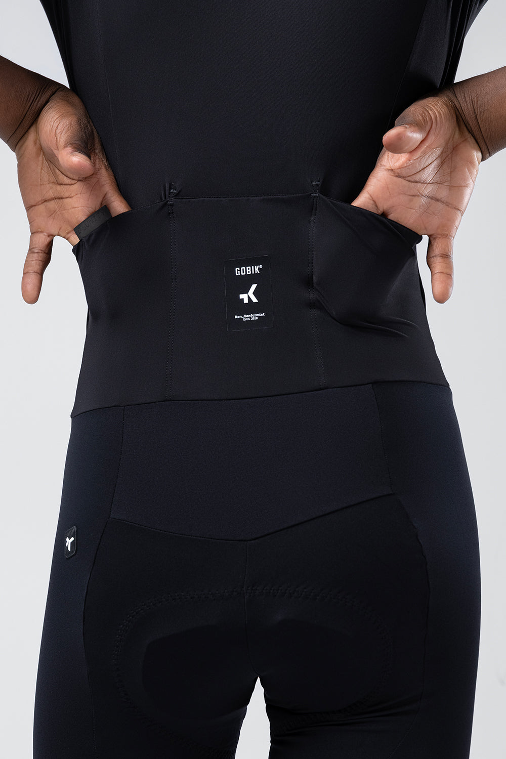 Close-up of Gobik cycling suit waist integration band showing brand label and connection system