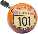 Electra bicycle bell featuring orange Highway 101 road sign design with sunburst pattern