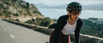 Cyclist wearing aquamarine Kask Valegro helmet while riding on scenic coastal road