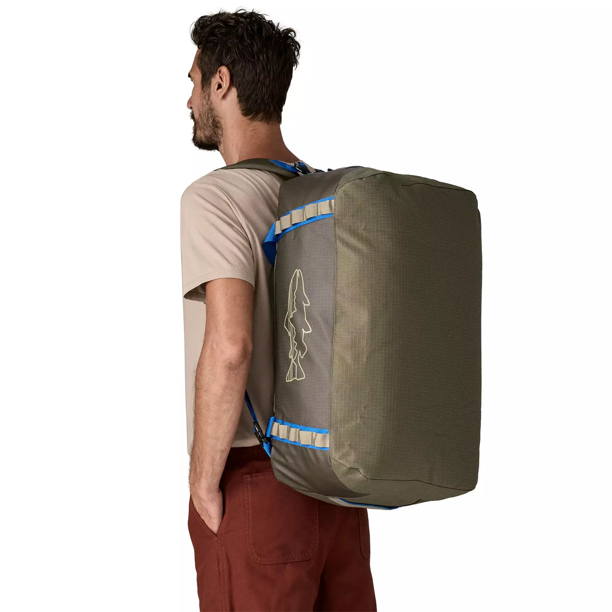 Man wearing Patagonia Black Hole Duffel 55L as backpack in Basin Green with Fitz Trout