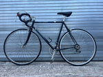 Peugeot head tube badge and black steel frame detail on 1980s French road bike