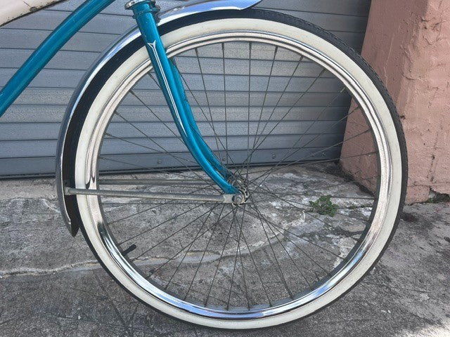 Handlebars with white grips and chrome detail on J.C. Higgins Flightliner