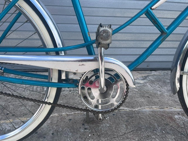 Chrome fenders and whitewall tires on vintage teal J.C. Higgins cruiser
