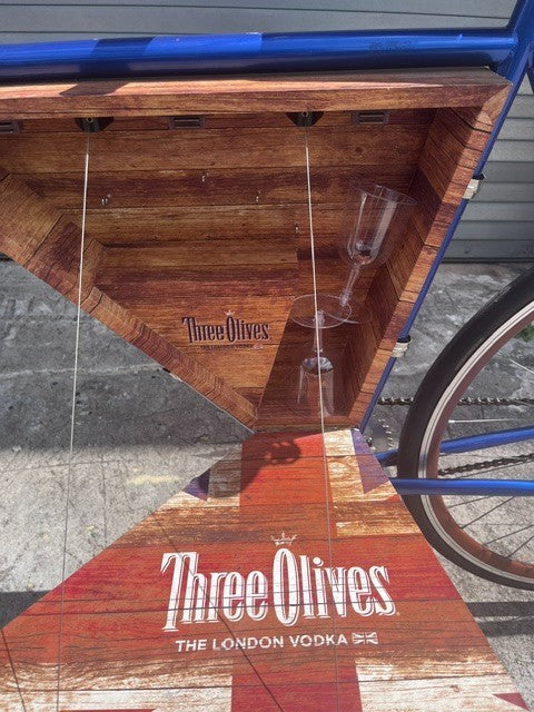 Three Olives Vodka branding and metallic blue paint detail on bar bike