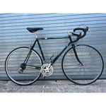 Vintage 1980s Peugeot 12-speed road bike in black, full side view