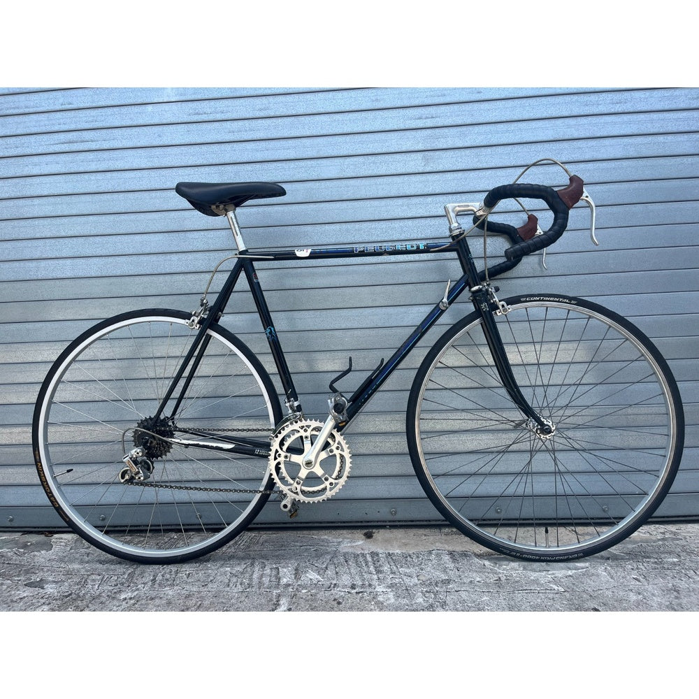Vintage 1980s Peugeot 12-speed road bike in black, full side view