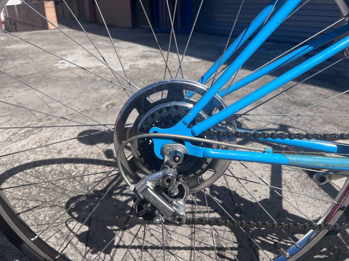 Rear derailleur, freewheel and chrome wheel detail on the Schwinn Le Tour Mixte