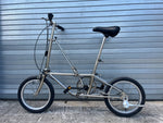 Dahon Classic III folded, showing compact fold and locking latch