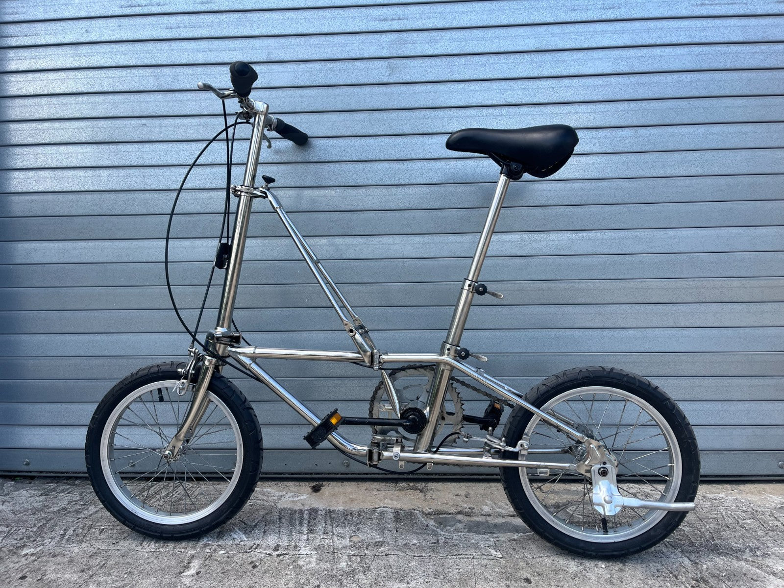 Dahon Classic III folded, showing compact fold and locking latch