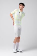 Male cyclist wearing Gobik CX Pro 4.0 jersey in white and neon yellow Drip pattern