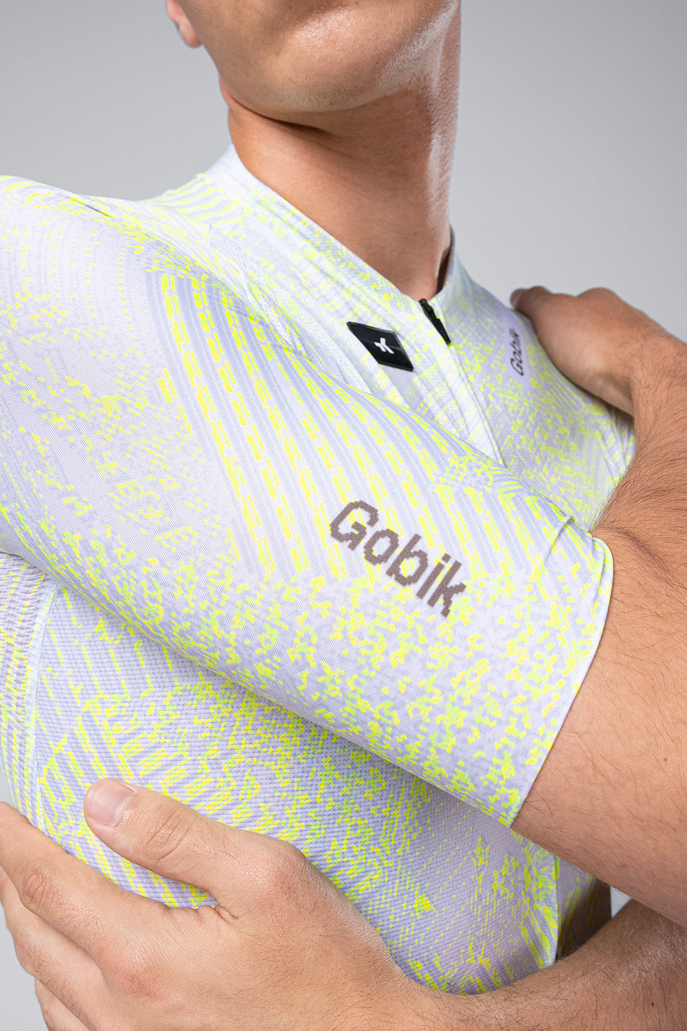 Gobik CX Pro Jersey in white with neon yellow pattern worn by cyclist