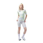 Woman wearing Gobik cycling jersey with neon yellow pattern and gray shorts