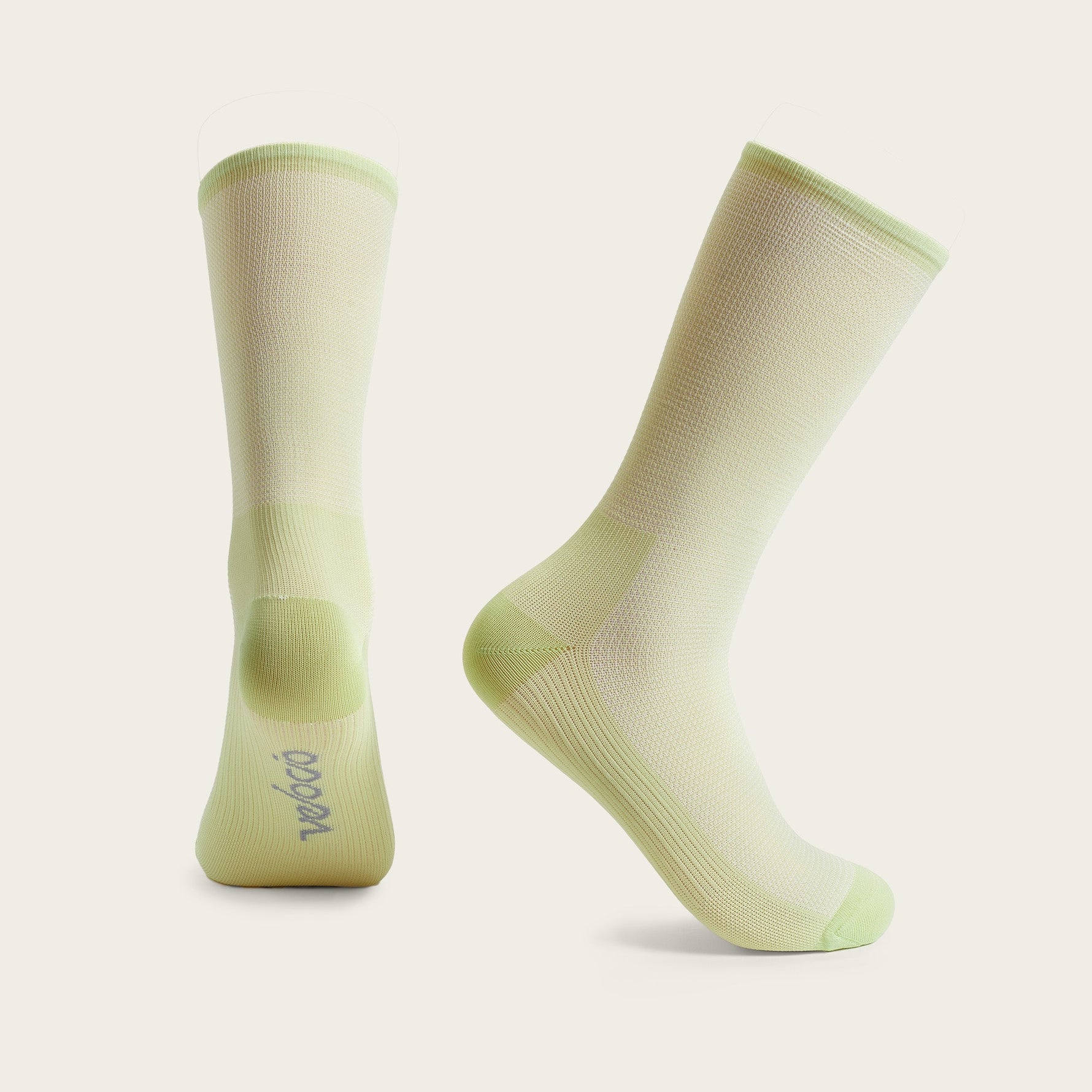 Velocio Ultralight cycling socks in sage green and cream colors