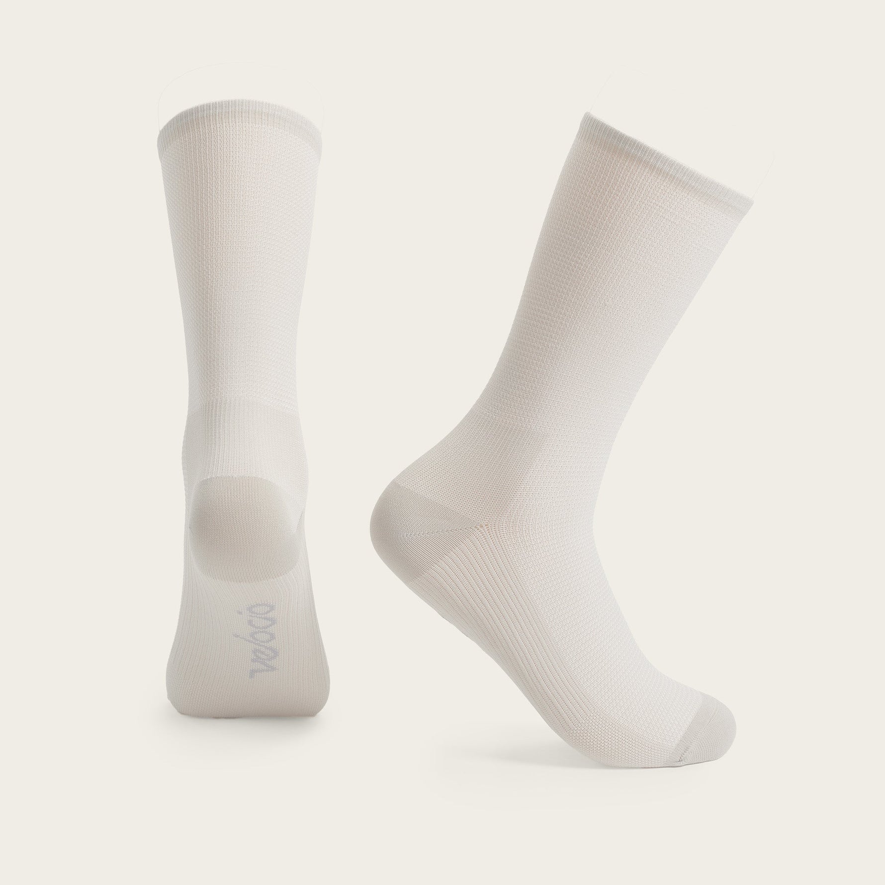 Pair of Velocio ultralight cycling socks in misty rose beige color