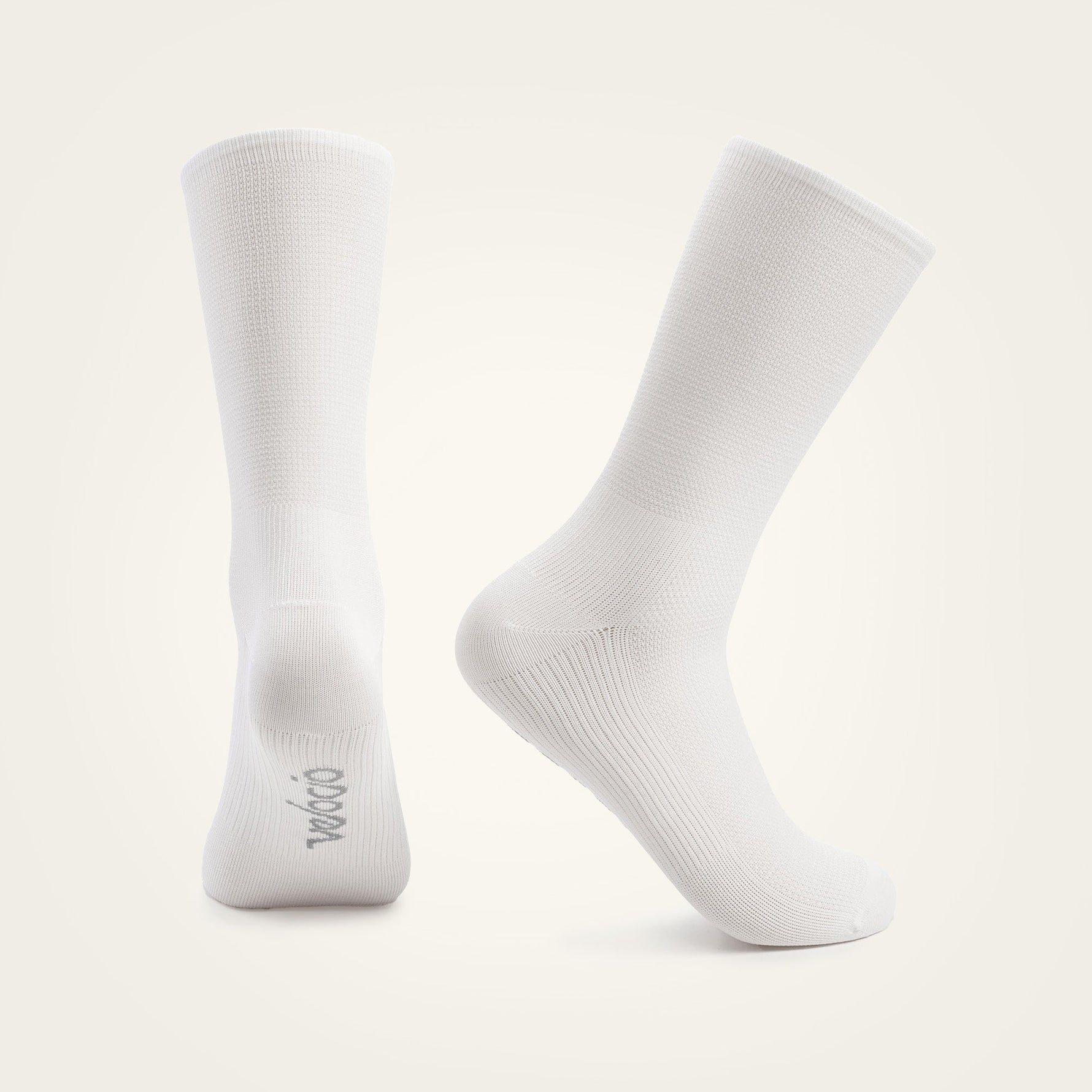 Two white Velocio ultralight crew socks on clean studio background